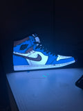 Actual blue, white and black high-top trainer lightbox standing on a white surface.