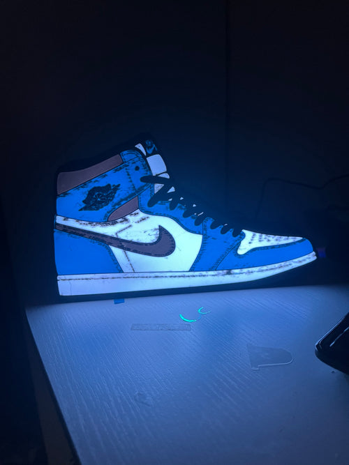 Actual blue, white and black high-top trainer lightbox standing on a white surface.