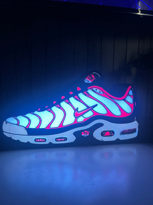 Actual illuminated Air Max Plus trainer lightbox with a white face and red outlines.